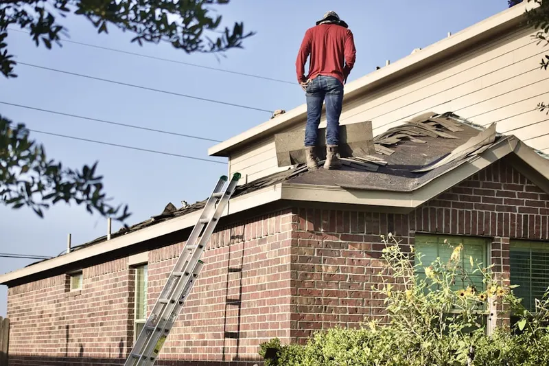 Professional roofer working on a residential roof in Mesa Terrace
